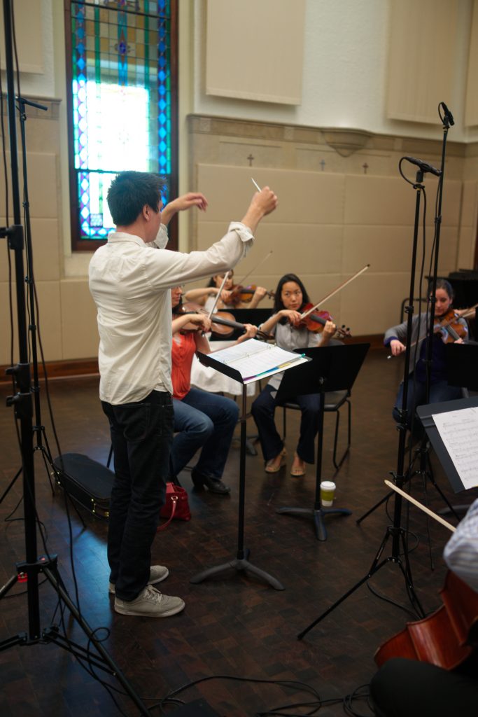 Tim Corpus conducting a string orchestra recording session.